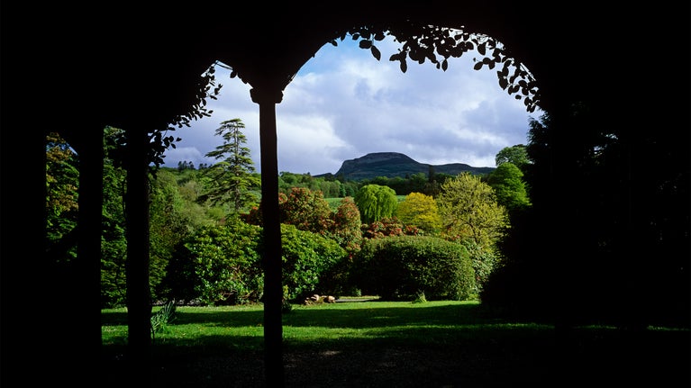 View from Summer House at Florence Court, Co Fermanagh, across the Pleasure Ground planted with ornamental trees and shrubs with a network of paths and in the background Ben Aughlin.